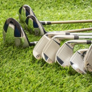golf-clubs-on-green-grass-golf-course-close-up-view-.jpg